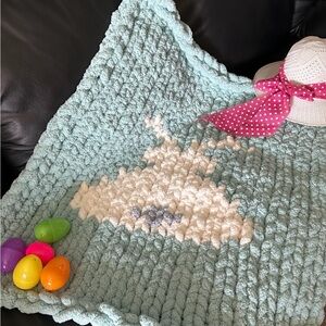 Handmade chunky knit mint coloured baby blanket with a cream coloured bunny.